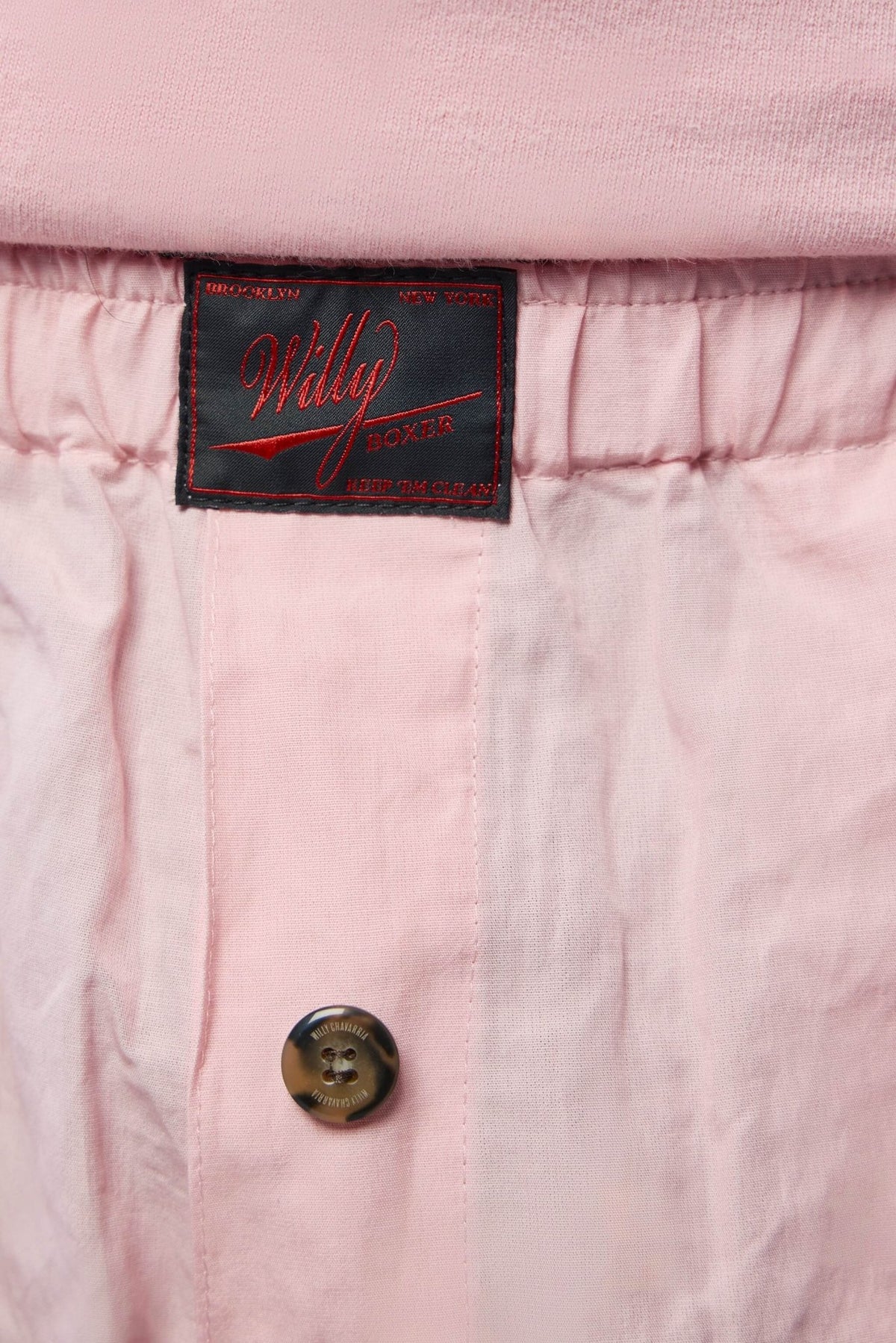 Side view showing elastic waistband and casual silhouette of designer shorts