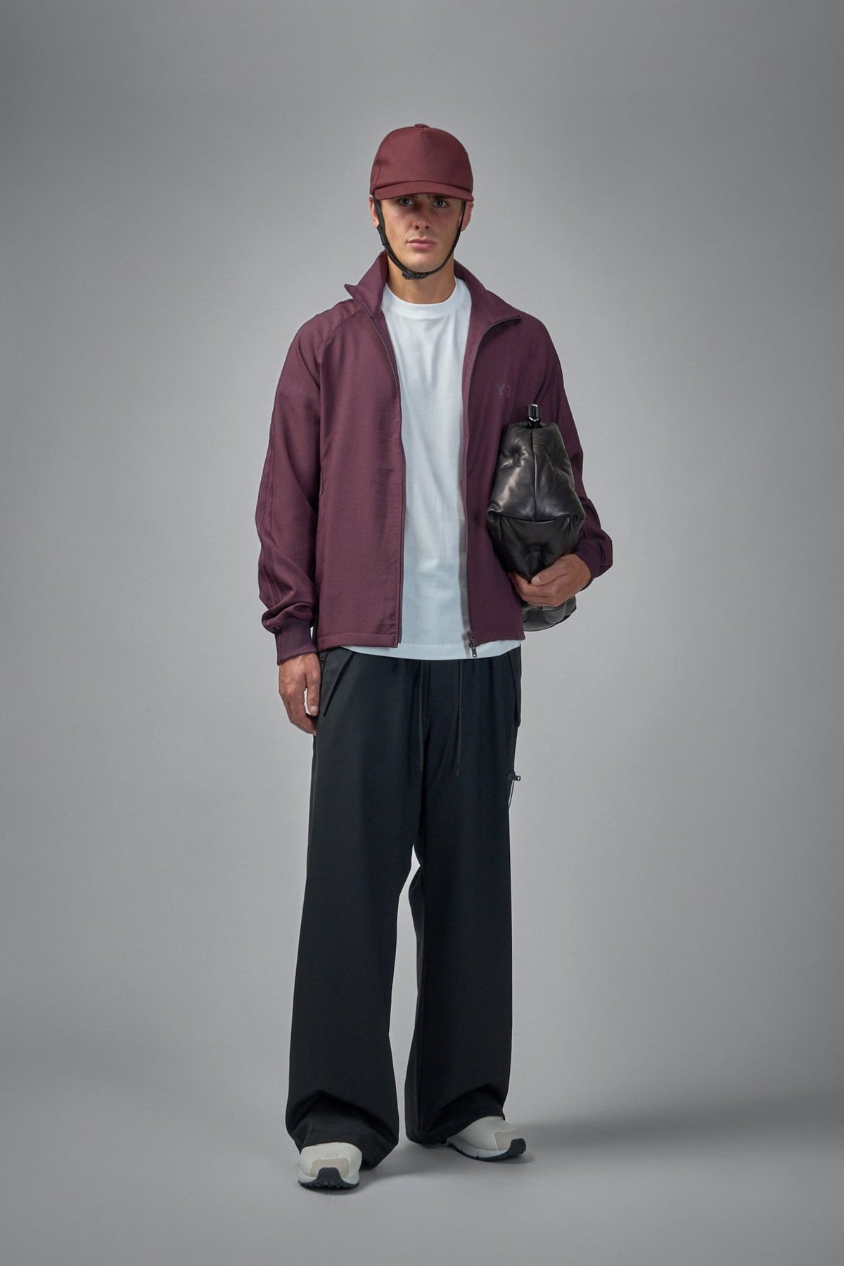Close-up of Y-3 track pants showing drawstring waist and minimalist branding