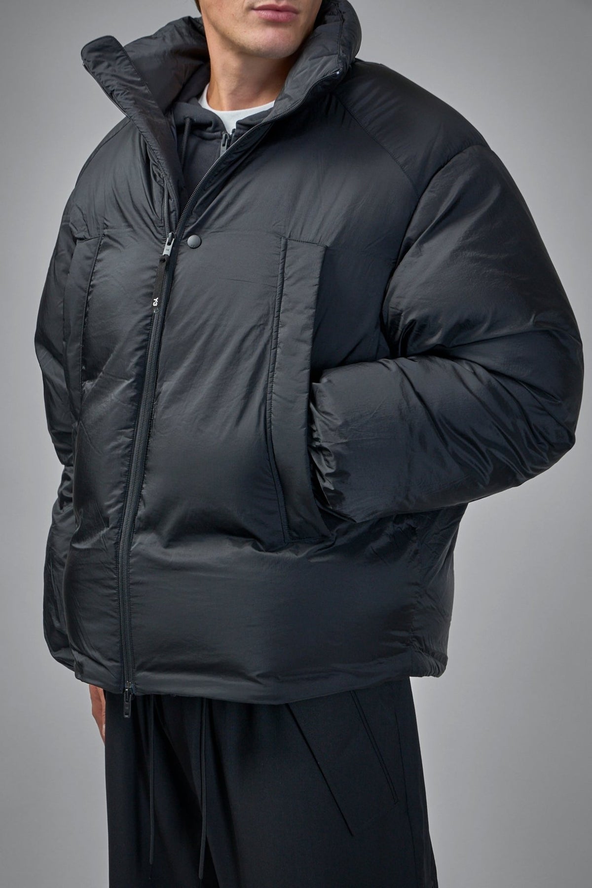 Detail shot of Y-3 jacket collar with snap button and high stand-up design