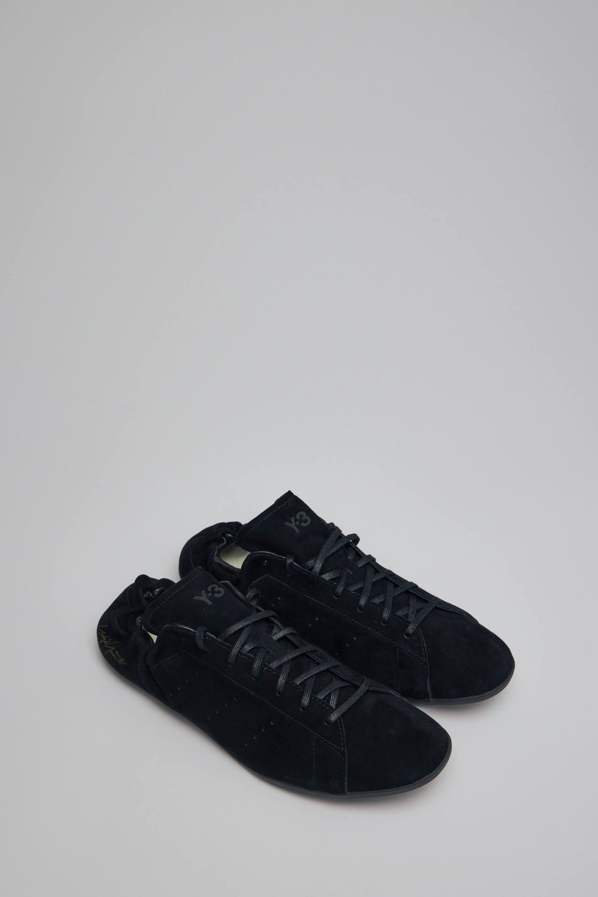 Side view of Y-3 Stan Smith Lo P sneakers showing textured leather upper and clean silhouette