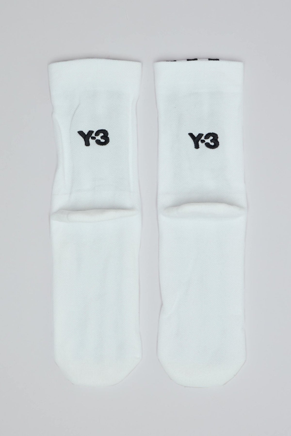 Above-ankle view of the Y-3 Yohji Yamamoto stripe sock ribbed cuff