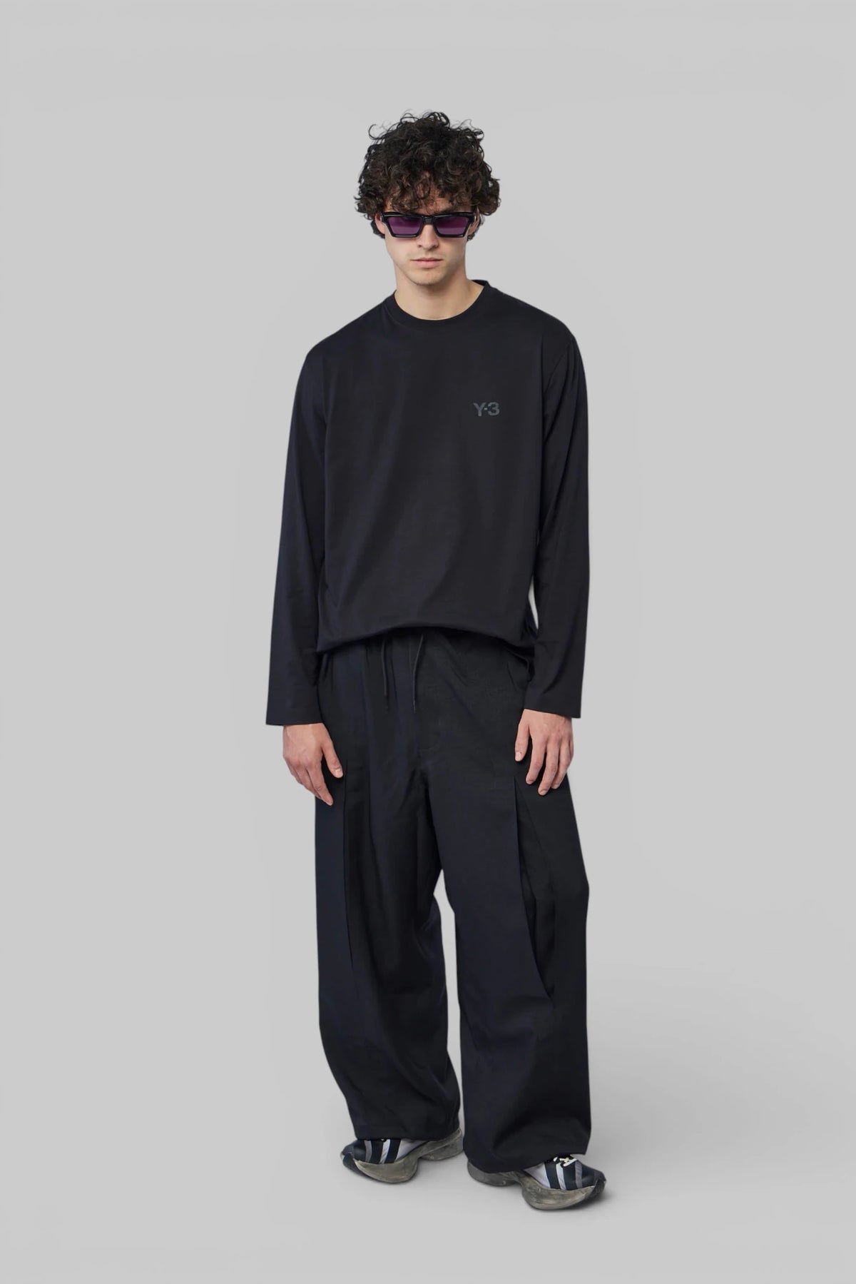 Close-up of Y-3 long-sleeve tee showing subtle chest logo and crew neckline