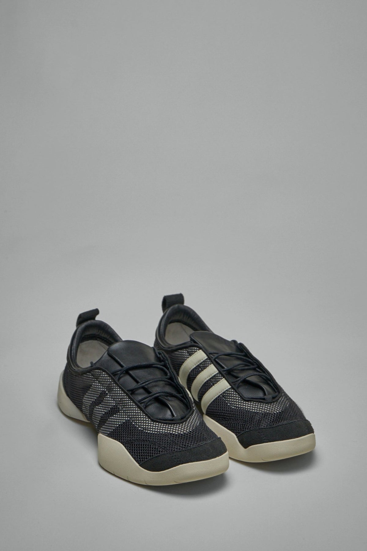 Side view of Y-3 Regu sneakers showing layered tongue design