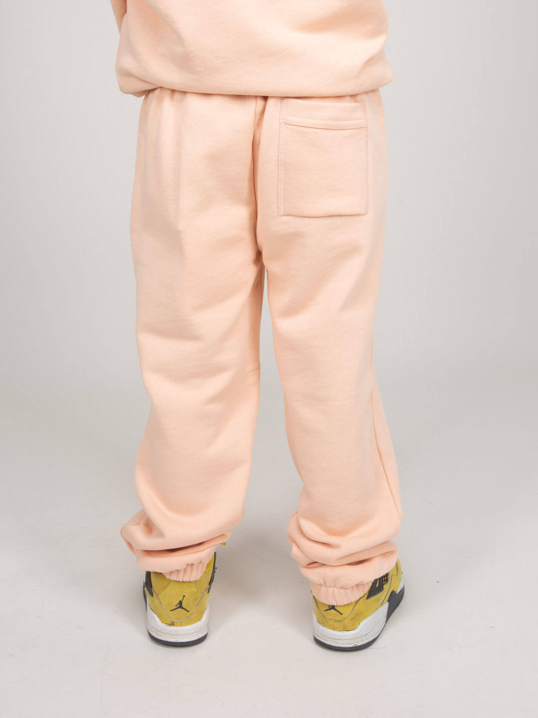 Side view showing functional pockets on children's track pants