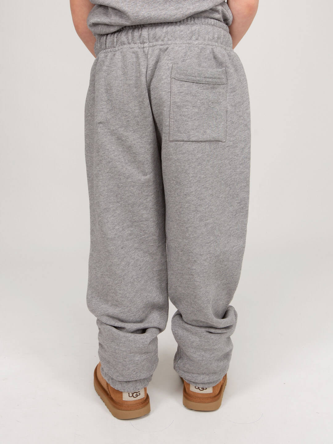 Close-up of Nash Face motif on Acne Studios track pants