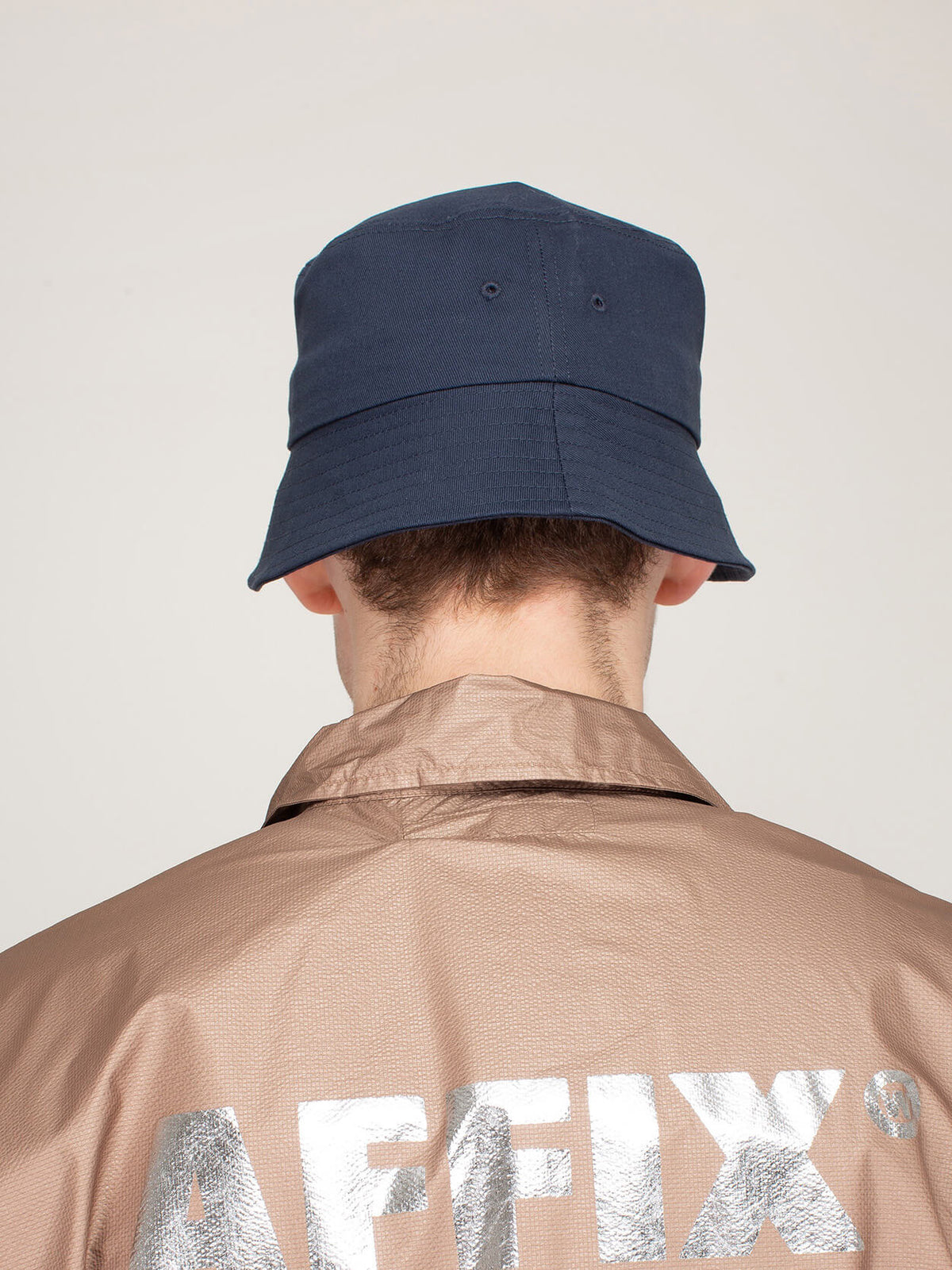 Side profile view of Affix nylon bucket hat showing deep fitting silhouette