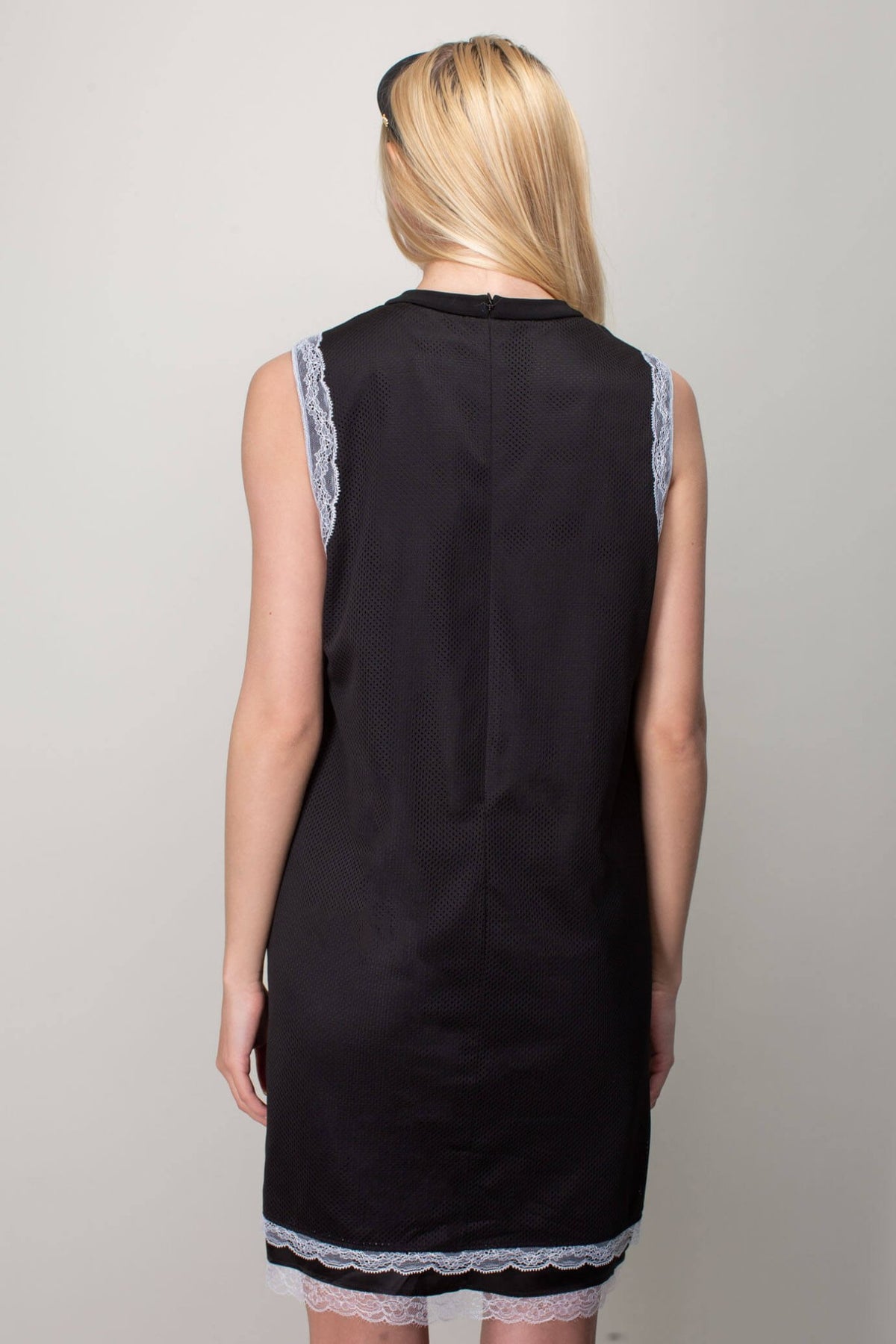 Full-length view of sleeveless mesh mini dress styling