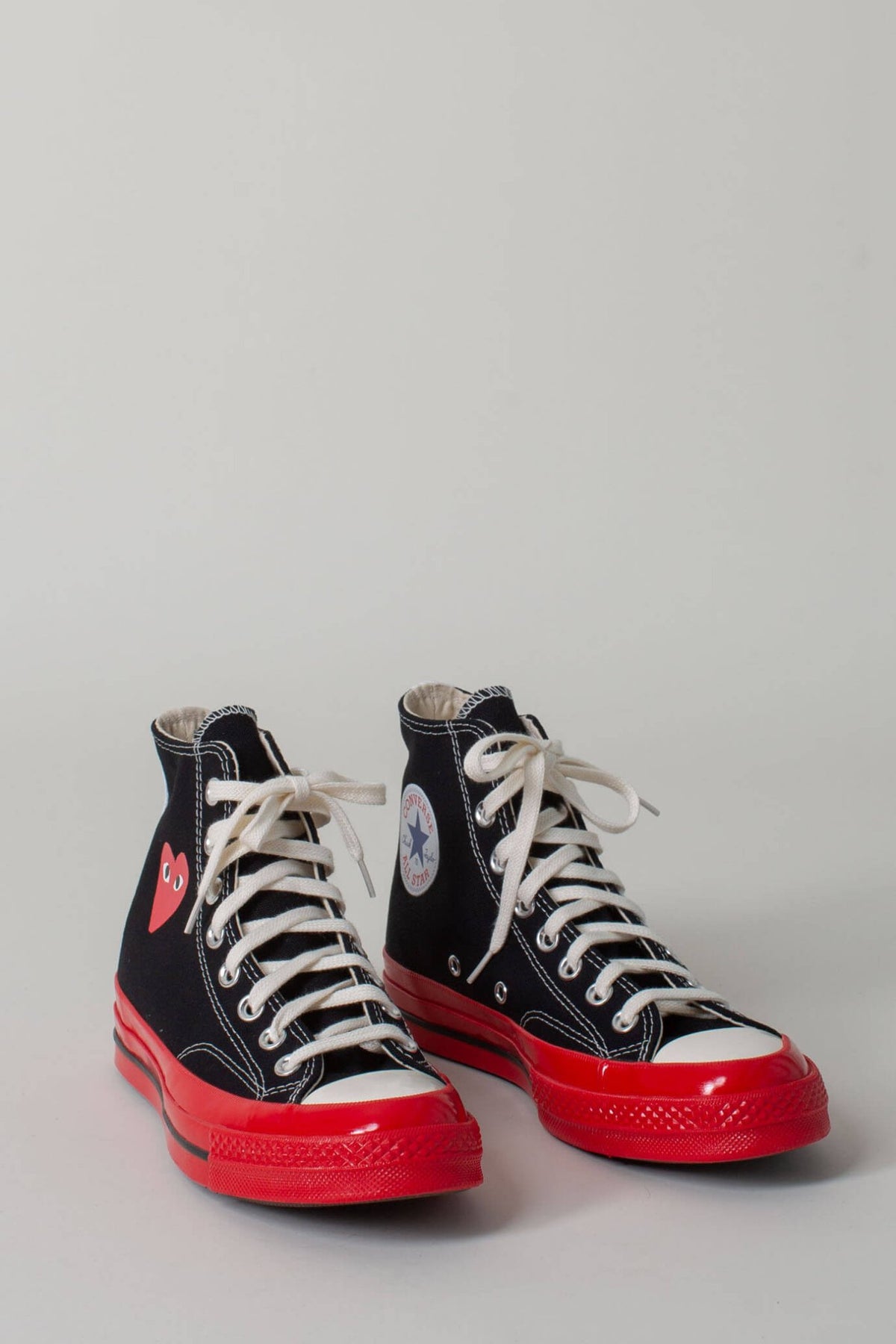 CDG PLAY high top sneakers side view showing iconic heart emblem