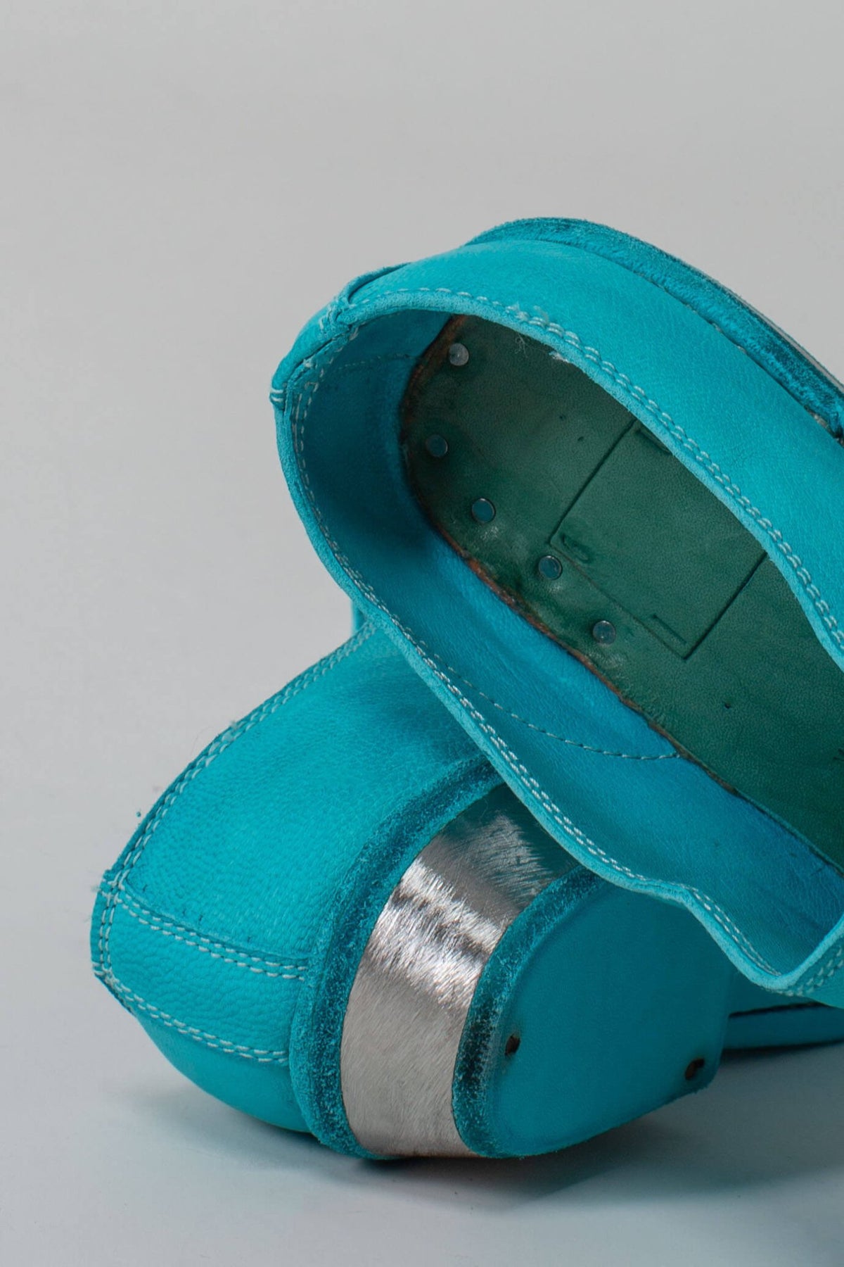 Detail shot of metal heel construction and leather finishing