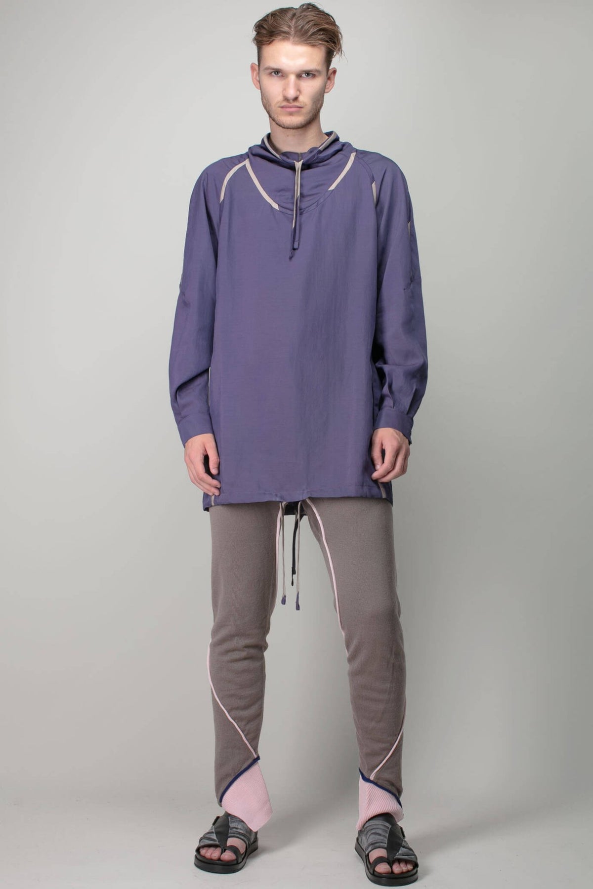 Model wearing Kiko Kostadinov cobble wool leggings with contemporary styling