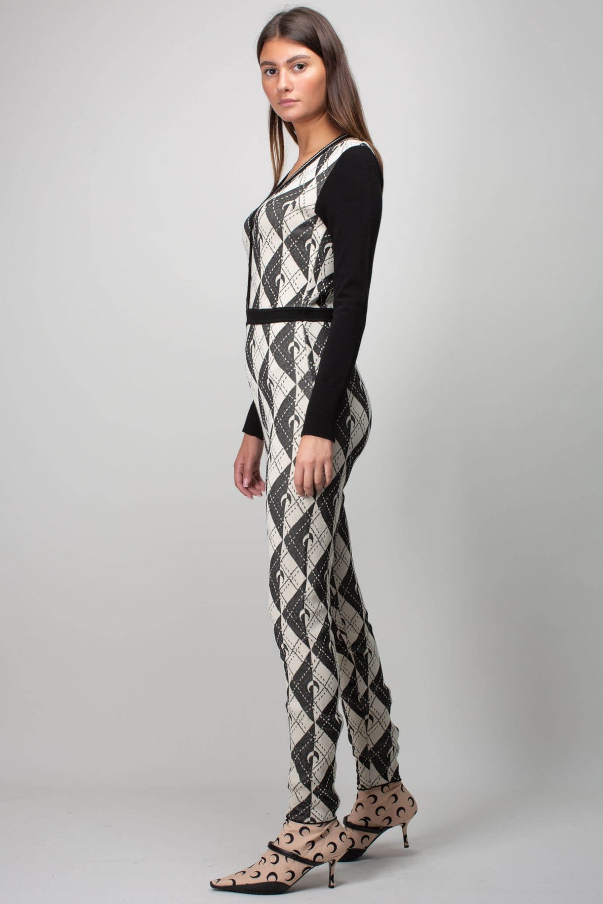 Close-up detail of Marine Serre catsuit checkered pattern and button closure